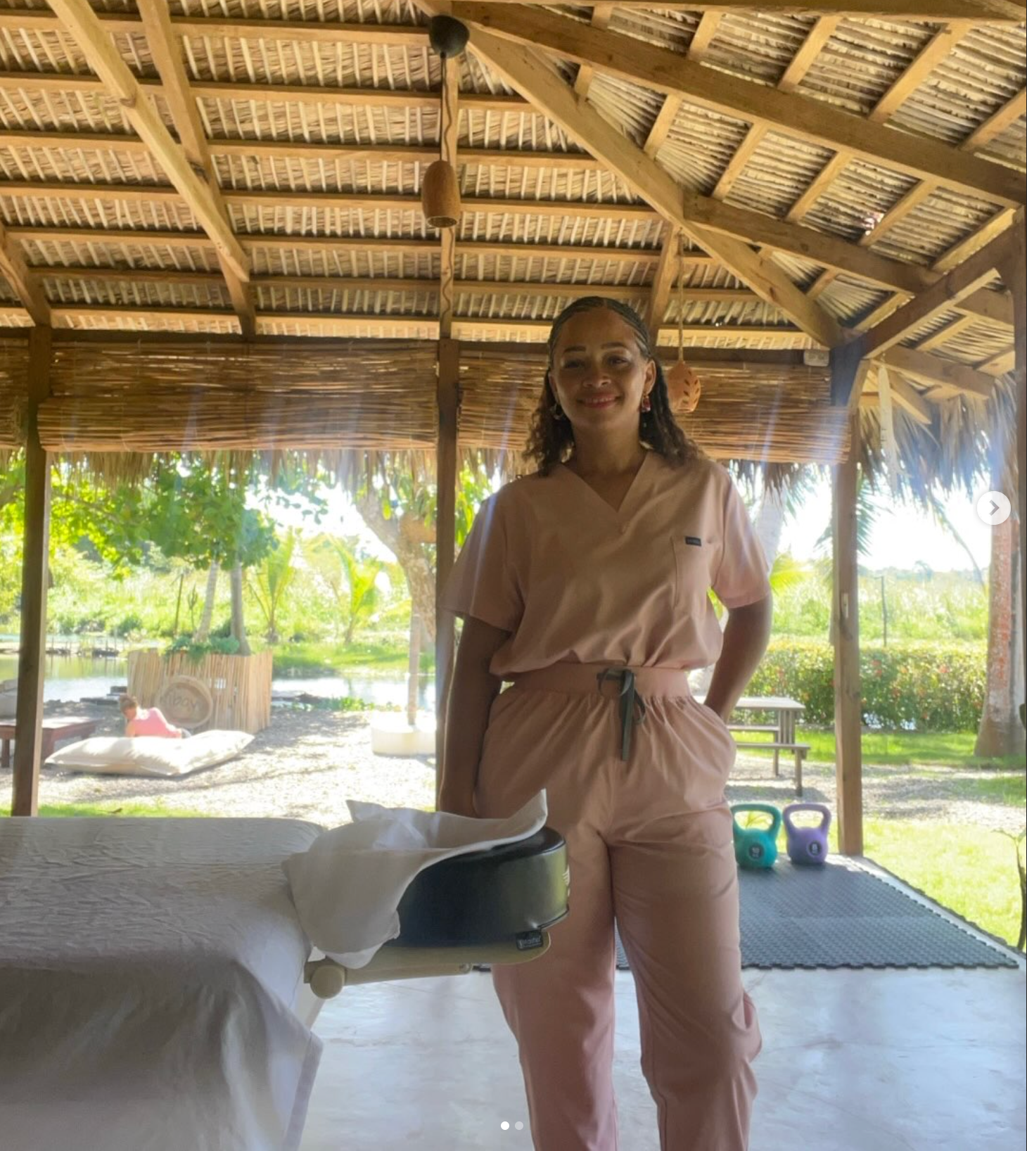 Melina, owner and massage therapist, beside her massage table